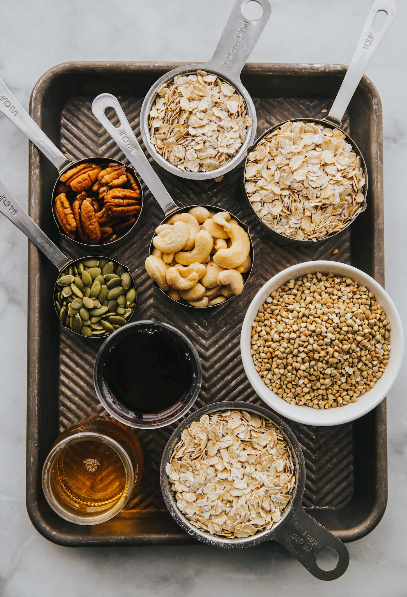 Cashews, oats, seeds, in measuring cups